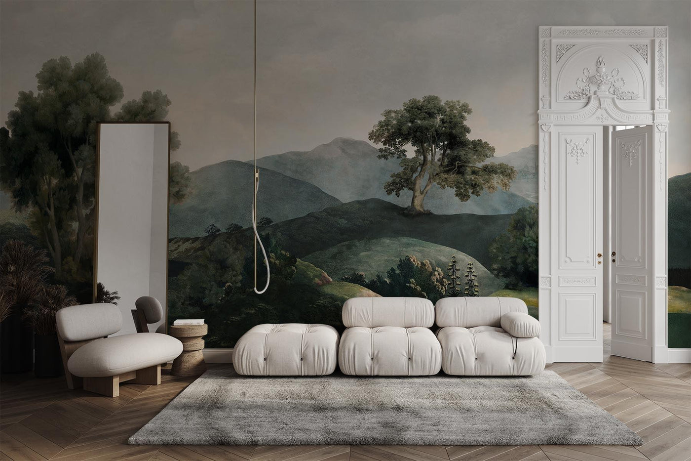 greene landscape wall mural on the wall of this living room. Wooden floor. White B&B Italia sofa. White chair. Grey rug