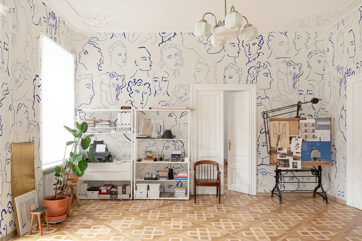 artistic wall mural on the wall of thsi working room filled wiht things